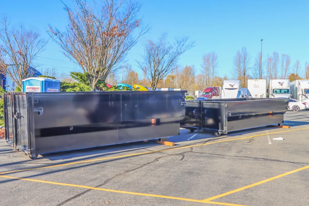 Professional dumpster rental service with roll-off container on residential driveway in Cherryland